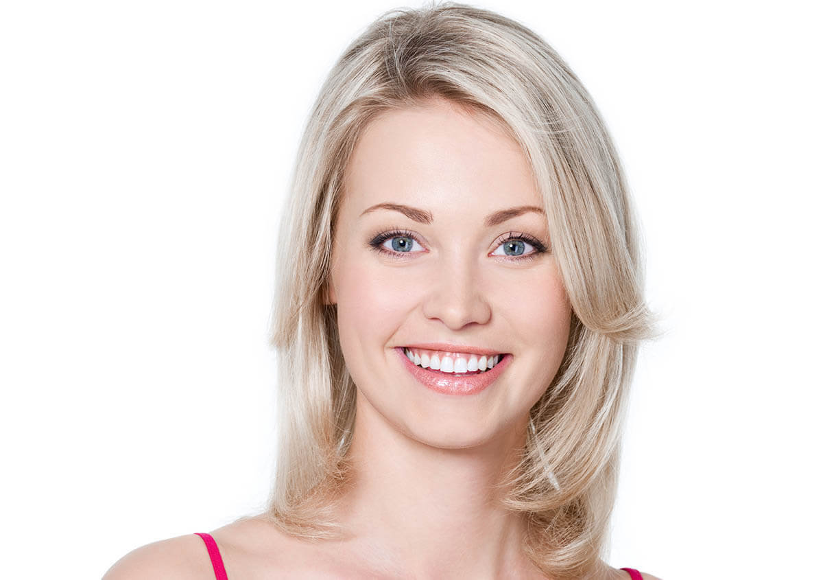 Smiling woman with healthy glowing skin after professional med spa facial treatment in Centerville, VA.